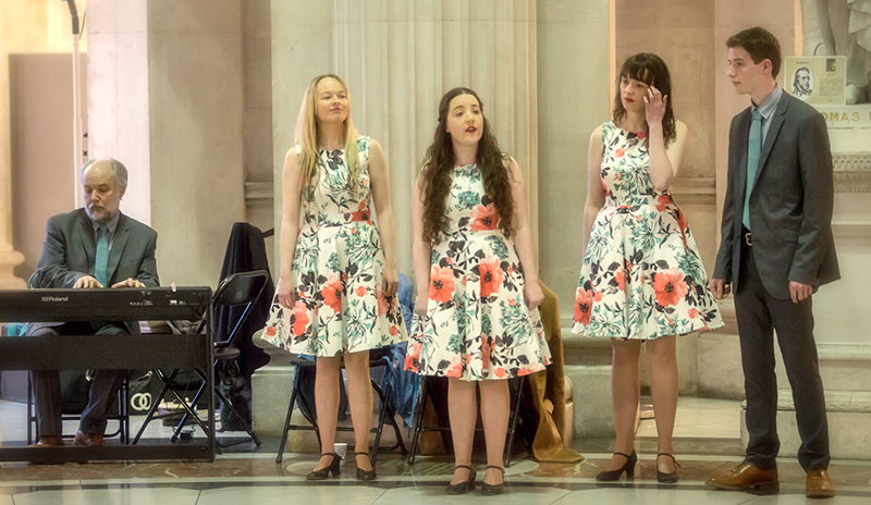 Classic Harmony, Frank Kelly at Keyboard with Rebecca, Orlaith, Emily and John Kelly standing as they perform in City Hall