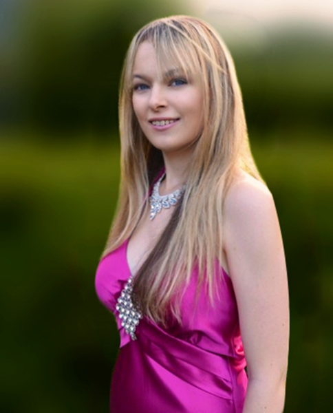 Rebecca Kelly in formal wear in a garden